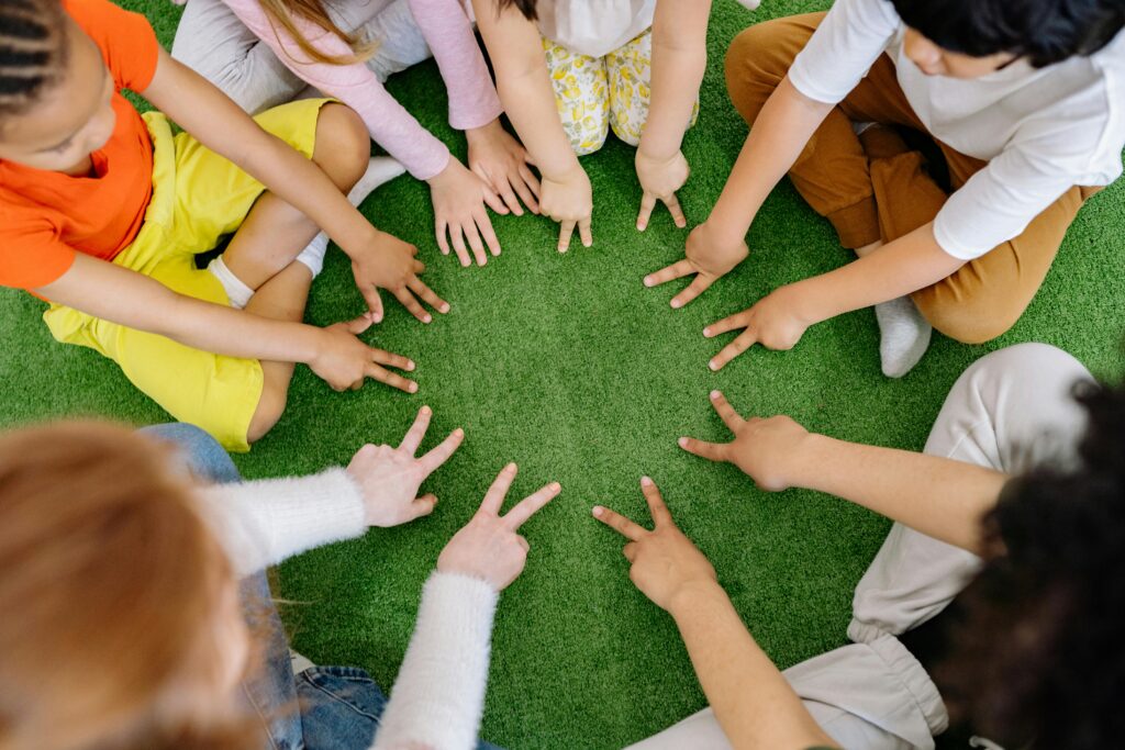 Image of children's hands in a circle.